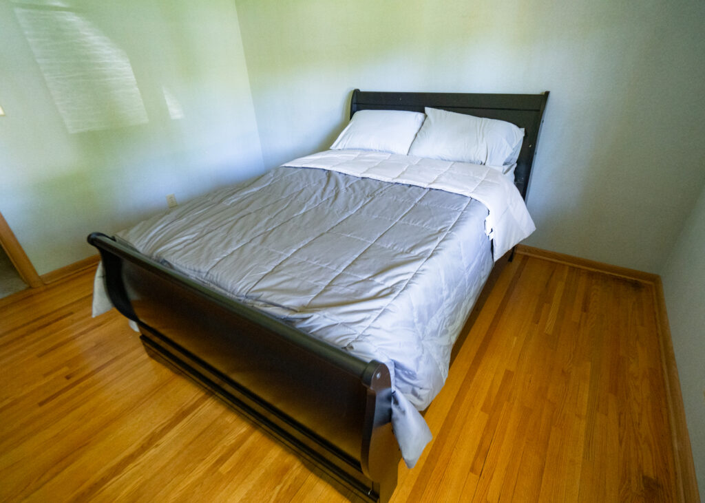 Bedroom with bed and wood flooring