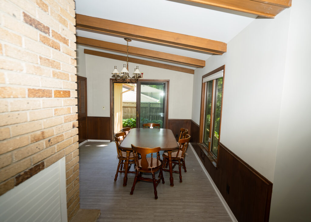 Dining area with table and brick fireplace